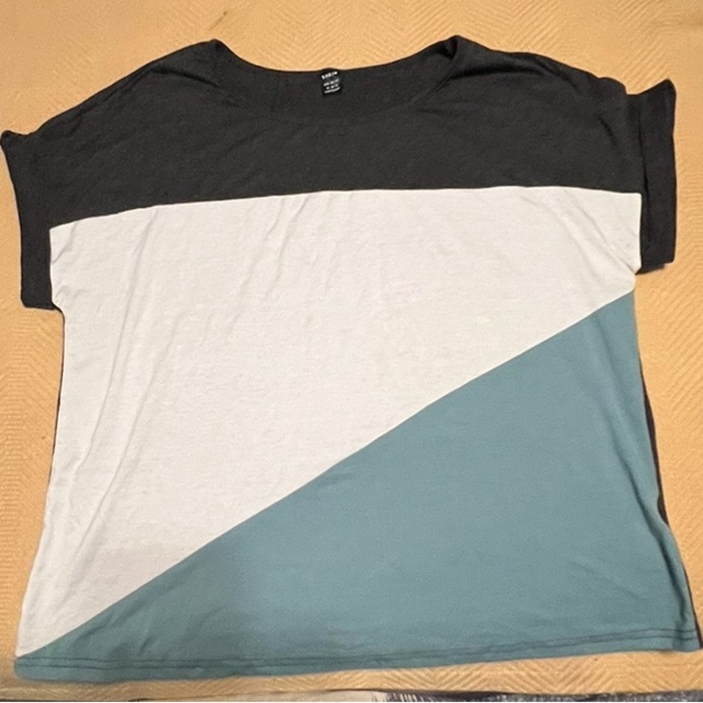 Shirt Is black, white & teal in a size XL. Never wore.